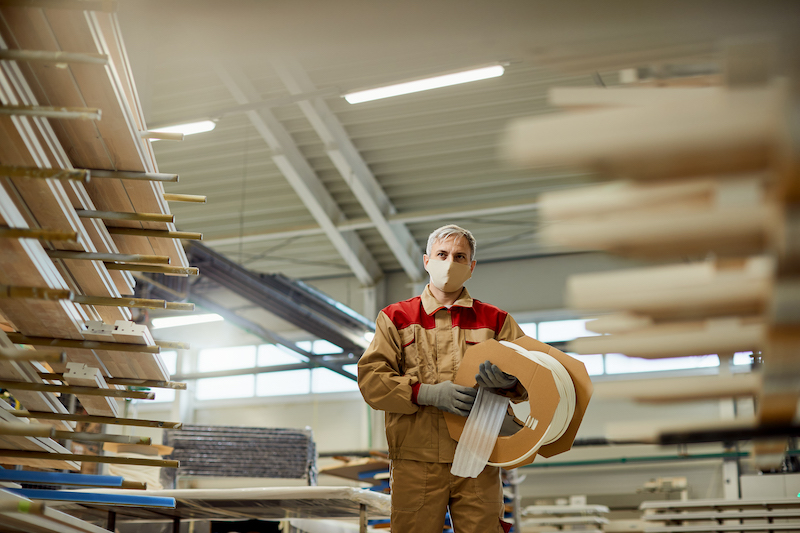 view-carpenter-carrying-protective-foam-while-working-workshop